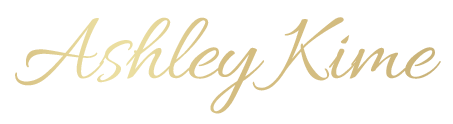 A black and gold logo for ashley j.